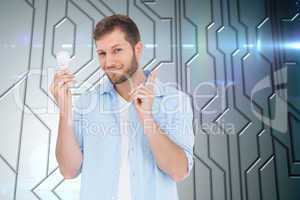 Composite image of charming model holding a bulb in right hand