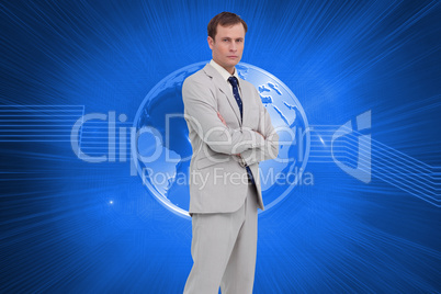 Composite image of serious businessman standing with his arms fo