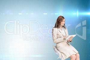 Composite image of happy businesswoman using tablet