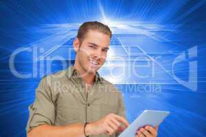 Composite image of happy man using tablet pc