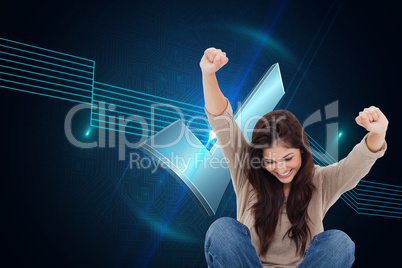 Composite image of brunette cheering while using laptop