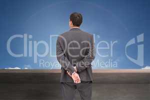 Composite image of rear view of classy businessman posing