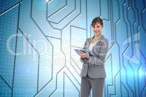 Composite image of smiling businesswoman with tablet computer