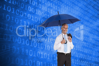 Composite image of happy businessman holding umbrella