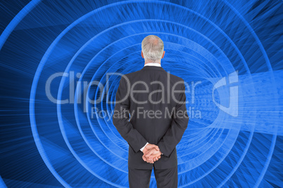 Composite image of rear view of serious businessman posing