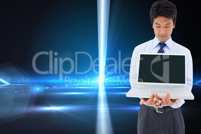 Composite image of businessman showing a laptop