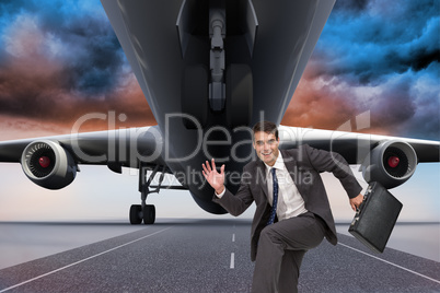 Composite image of happy businessman in a hury