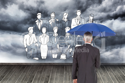 Composite image of businessman holding umbrella