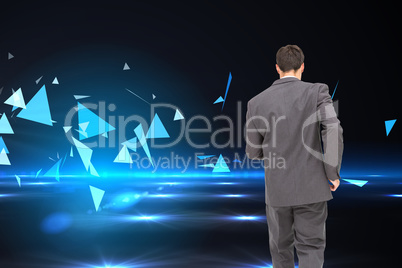 Composite image of young businessman walking away from camera