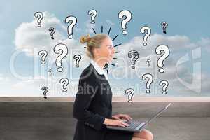 Composite image of businesswoman using laptop