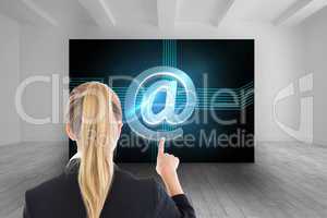 Composite image of business woman pointing somewhere