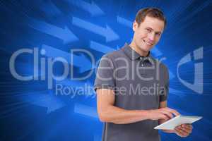 Composite image of smiling young man with tablet computer