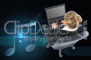 Composite image of businesswoman sitting on swivel chair with la