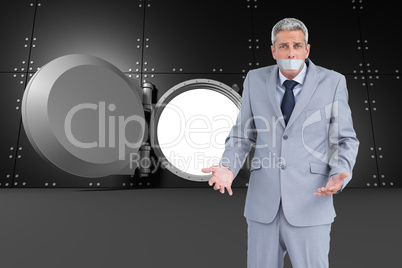 Composite image of businessman gagged with adhesive tape on mout