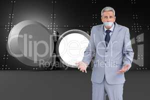 Composite image of businessman gagged with adhesive tape on mout