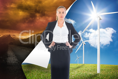 Composite image of businesswoman standing with hands on hips