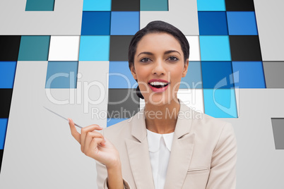 Composite image of smiling businesswoman holding a pen