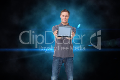 Composite image of young man showing screen of his tablet comput