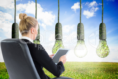 Composite image of businesswoman sitting on swivel chair with ta