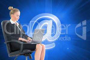 Composite image of businesswoman sitting on swivel chair with la