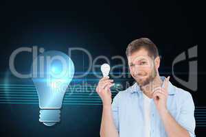 Composite image of charming model holding a bulb in right hand