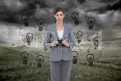 Composite image of young businesswoman with binoculars