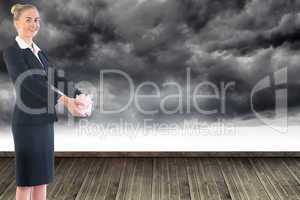 Composite image of businesswoman holding pink piggy bank