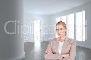 Composite image of confident female executive with folded arms