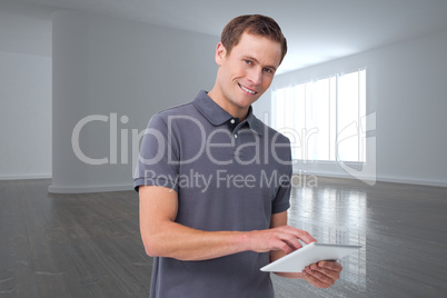 Composite image of smiling young man with tablet computer