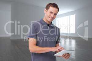 Composite image of smiling young man with tablet computer