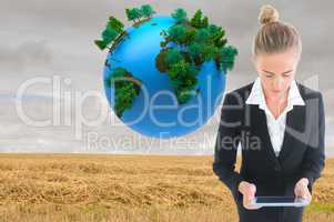 Composite image of businesswoman holding new tablet