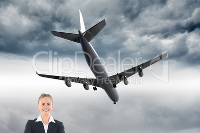 Composite image of happy businesswoman holding a piggy bank