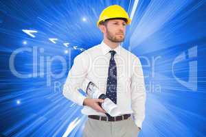 Composite image of young architect posing with hard hat and plan