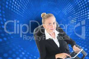 Composite image of businesswoman sitting on swivel chair with ta