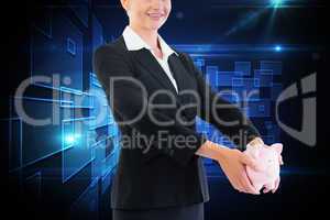 Composite image of businesswoman holding piggy bank