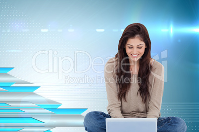 Composite image of brunette sitting on floor using laptop