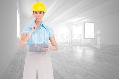 Composite image of thoughtful attractive architect holding clipb