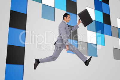 Composite image of businessman running with a suitcase