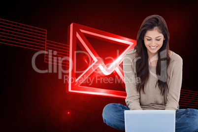 Composite image of brunette sitting on floor using laptop