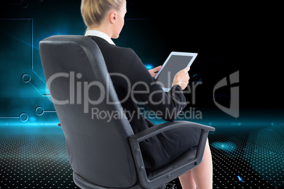 Composite image of businesswoman sitting on swivel chair with ta