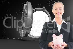 Composite image of businesswoman holding piggy bank