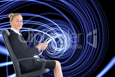 Composite image of businesswoman sitting in swivel chair holding