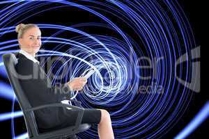 Composite image of businesswoman sitting in swivel chair holding