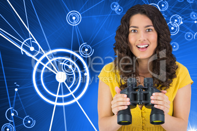 Composite image of smiling casual young woman holding binoculars