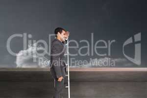 Composite image of happy businessman standing on ladder