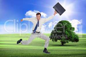 Composite image of cheerful jumping businessman with his suitcas