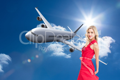 Composite image of smiling blonde turning