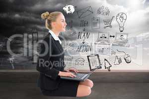 Composite image of businesswoman using laptop