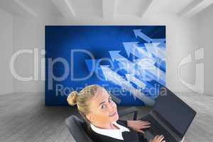 Composite image of businesswoman sitting on swivel chair with la