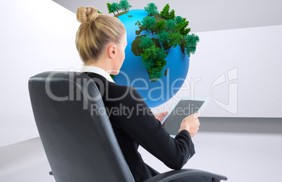 Composite image of businesswoman sitting on swivel chair with ta